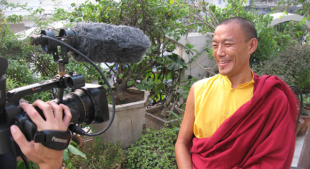 Film camera recording a monk