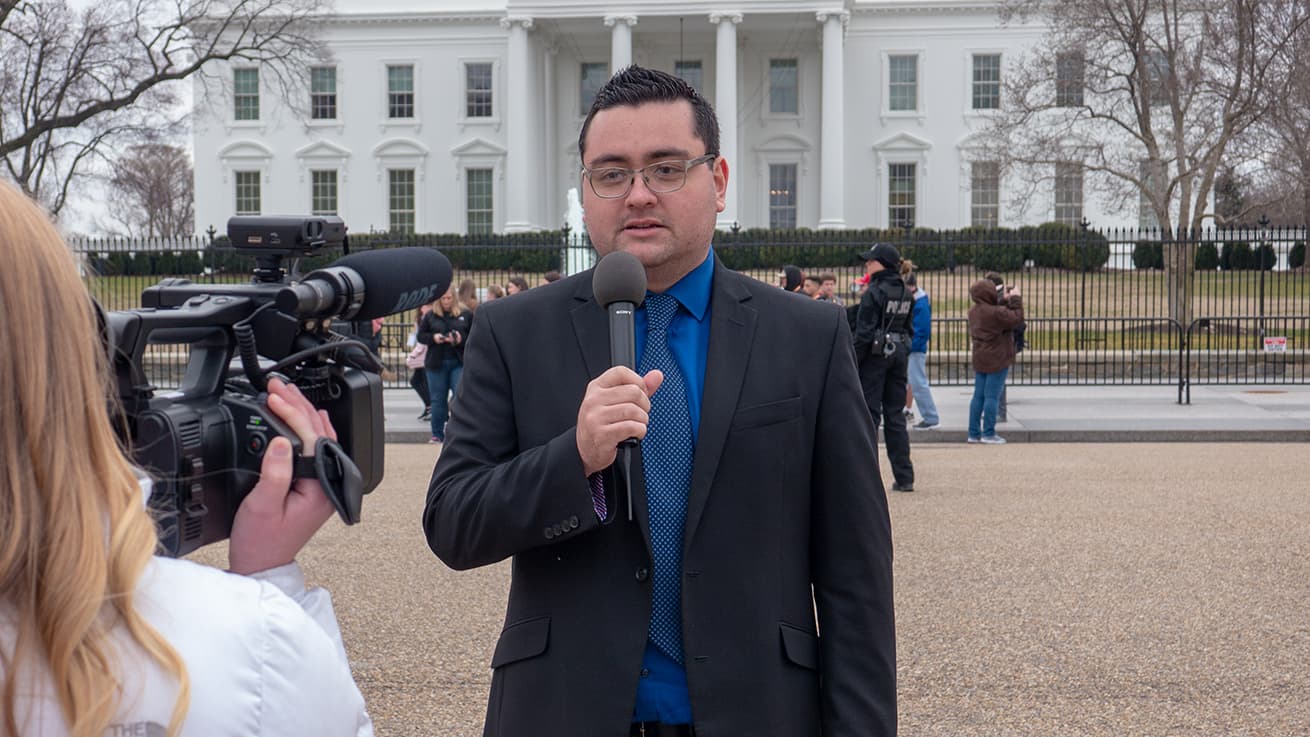 Man reporting in front of White House