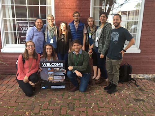 eleven American University film students pose around ACFF sign