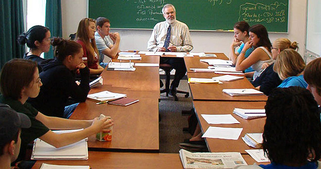 SOC Comm Studies Joe Campbell and students around table