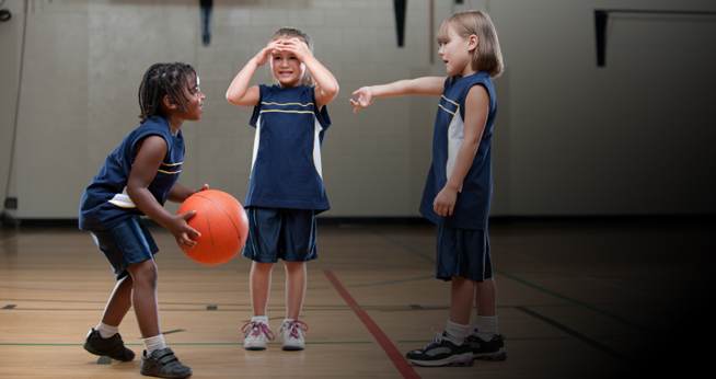 Photo of three girls playing basketball