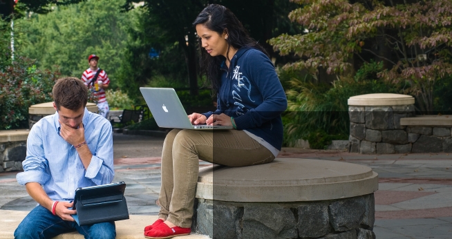 Students use laptops and tablets outside.