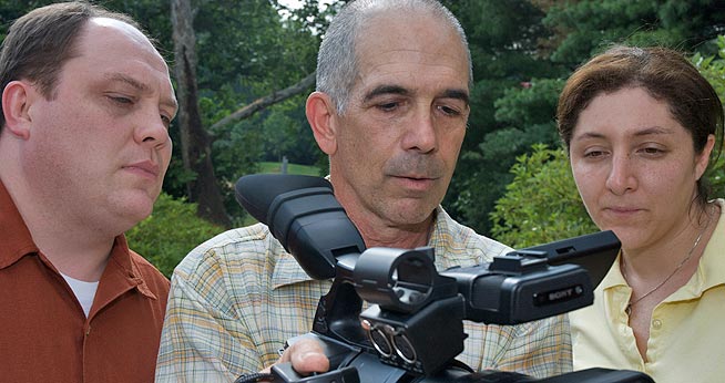 Professor Larry Engel shows students the camera  they will use to film during the Classroom in the Wild, Alaska program.