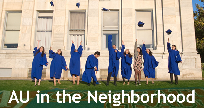 Graduates throwing graduation caps into the air.