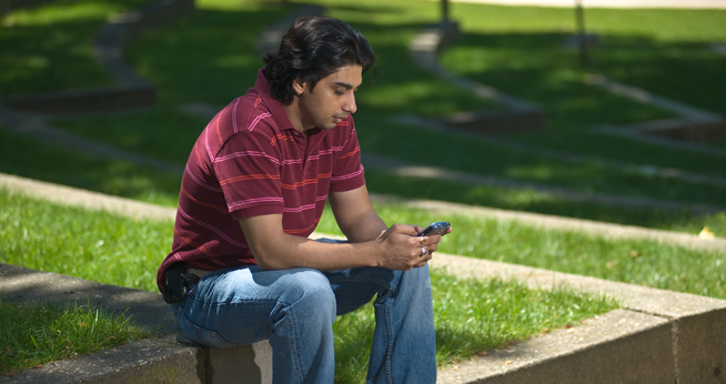 AU Staff Member Using Blackberry Outdoors