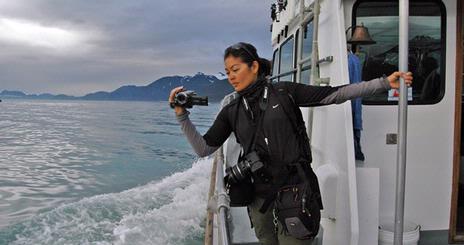 Arlene Agulto, one of twelve students who traveled to Alaska for <em>Classroom in the Wild: Extreme HD</em>, films whales.