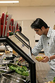 A student checks out the cafeteria's salad bar.