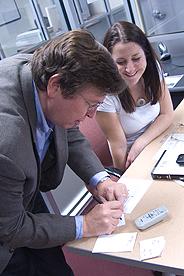 Faculty writing a note for a student