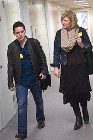 Faculty member mentoring a student while walking down a hallway