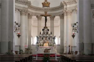 Mostly white church, with white and gold altar.