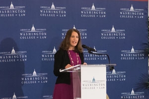 AU president Sylvia Burwell speaking at a lectern at the Washington College of Law.