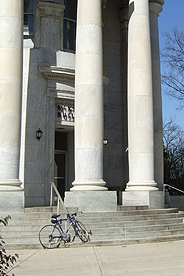 Photo of front steps of McKinley Building on AU's main campus, with bicycle leaning on the steps