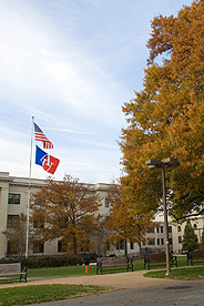 Picture of flagpole on the Quad with the AU and American flags waving in the wind
