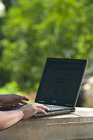 Picture of student's hands on laptop while working on the Quad