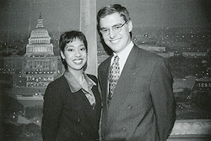 Sonya Gavankar and a male colleague stand in front of a Washington, DC backdrop on an American University Television set in 1999.