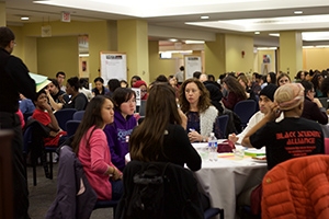 Scores of students at tables attend a portion of the teach-in.