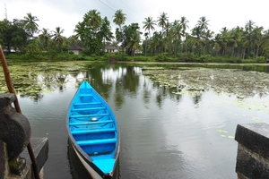 River and blue canoe. Varanga Temple background. Karkala, Karnataka.