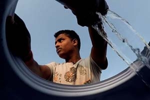Man pumps water in India. Photo by Steve Elfers.