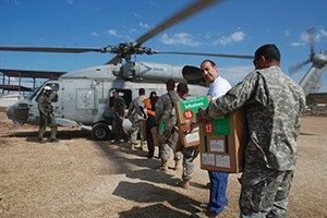 Dr. Malek Sbih unloads vaccines from a helicopter.
