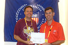 J.C. Brooke, ’95, receives a certificate of appreciation for his work and support of the 2008 U.S. Olympic Team during the Games of the XXIX Olympiad in Beijing, China.&nbsp;