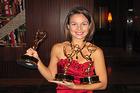 SOC Alumna Janet Rodriguez poses with her most recently won Regional Emmys.