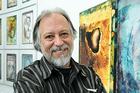 Don Kimes by his paintings.