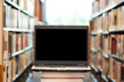 Laptop in a row of library books