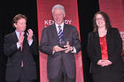 President Bill Clinton accepts the Wonk of the Year award from President Neil Kerwin and Alex Kreger, student director of the Kennedy Political Union.