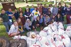 Faculty and students participate in a community clean-up day.