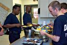 Photo: Firefighters help themselves to dinner cooked by their colleague, Danny Faison