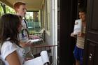 Freshmen assist with a door-to-door community survey during the Freshmen Service event.