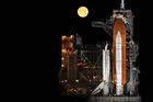 Photo: Under a nearly full moon, the space shuttle Discovery sits atop a launch pad at the Kennedy Space Center. 