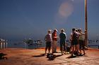 Photo - Allan Baer, left with hat, one of the founders of SolarQuest, set up a trip for AU students to meet with local fishermen  in San Cristobal caught in the middle of the age-old struggle between conservation and development.
