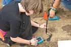 Photo: Students in Professor Kiho Kim's Sustainable Earth class plant an experimental garden outside Beeghly Hall.