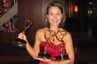 Janet Rodriguez holds her 3 Emmy Awards