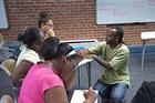 Photo: Babatunde Pyne works with students in SETH's POWER program.