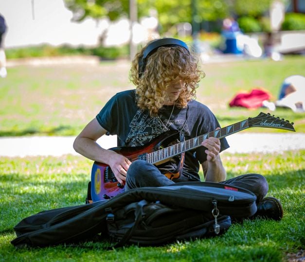 Student Playing Guitar