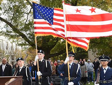 Military students holding American Flag and DC Flag