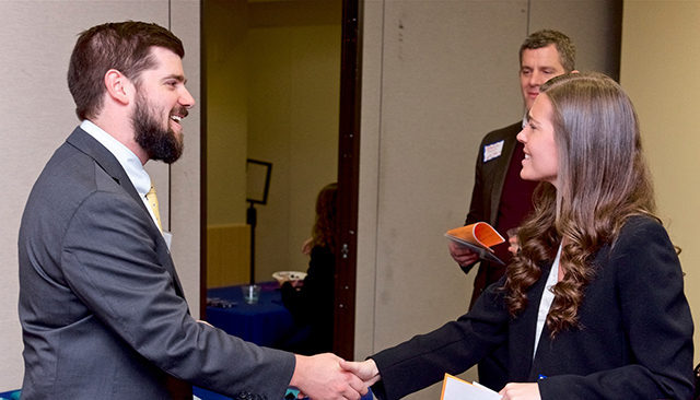Alumnus and student shaking hands