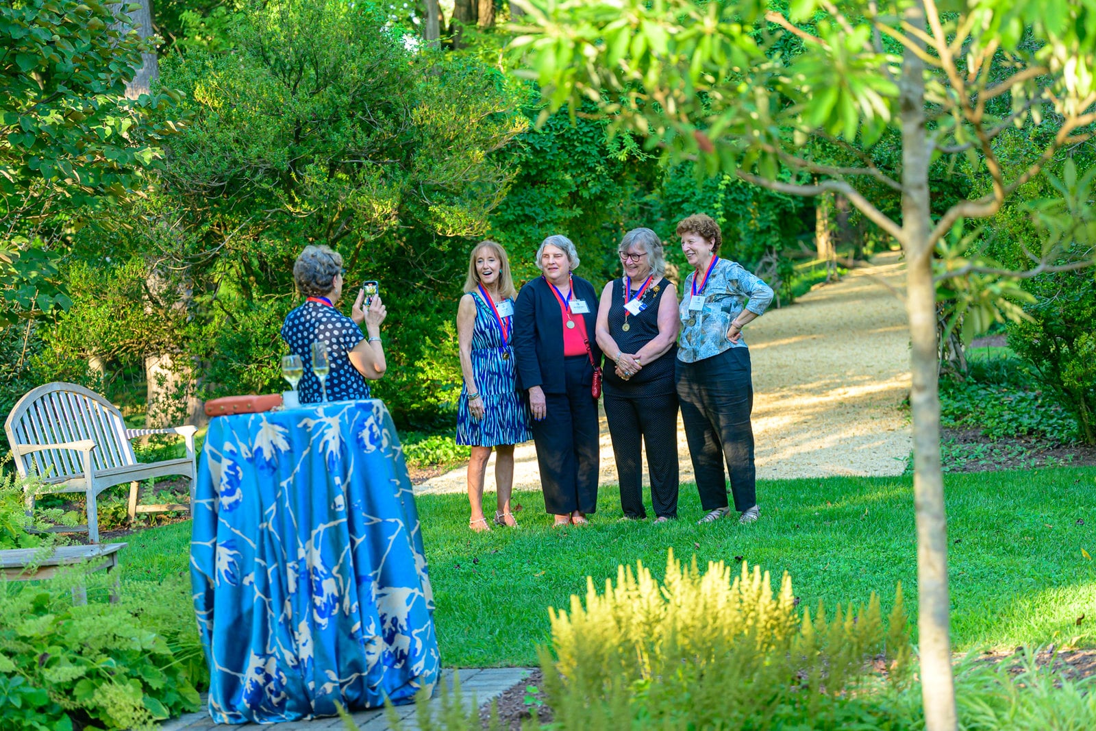 A group of alumni pose for a photo outside. 