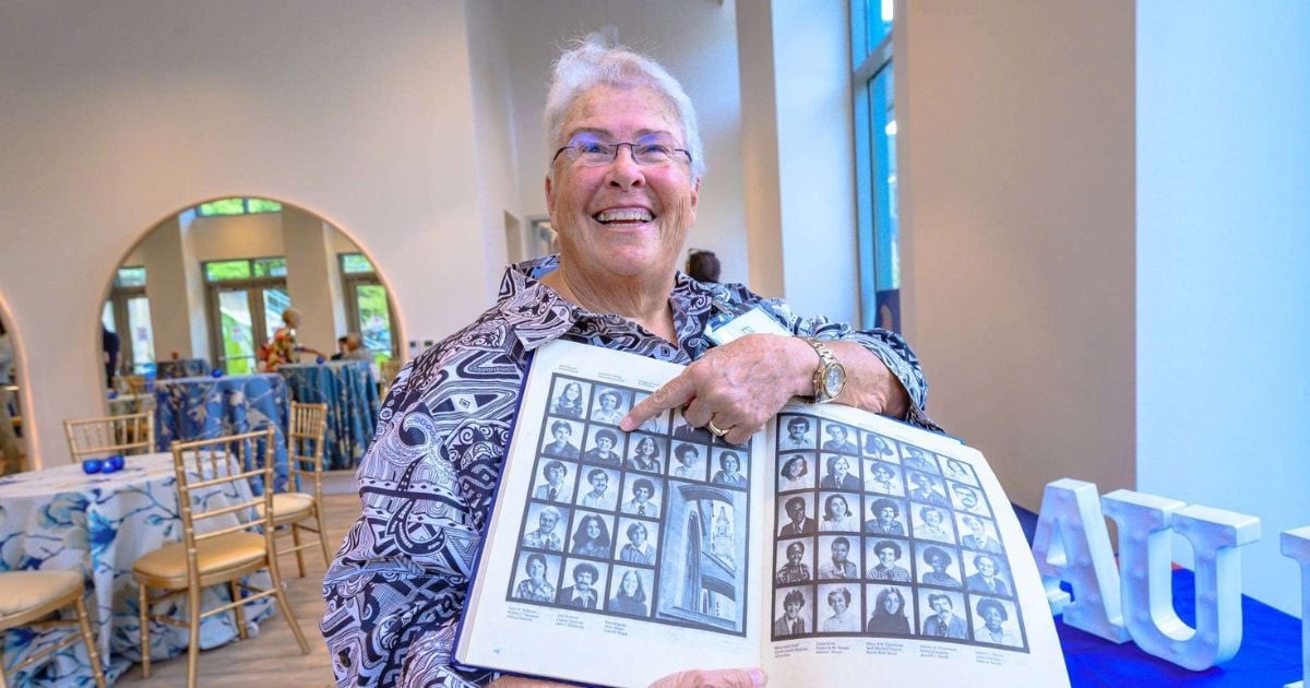 GE Class of 1976 alum looking through yearbook GE Class of 1976 alum looking through yearbook