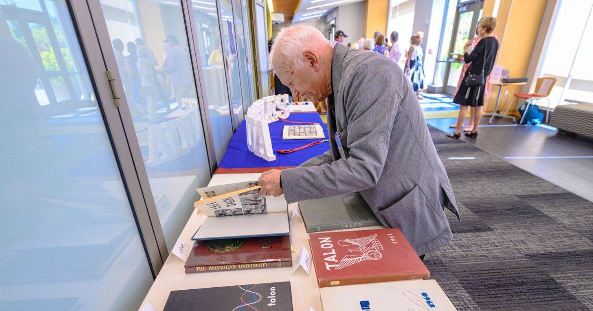 GE looking through yearbook GE looking through yearbook