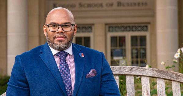 Jonathon Mathis sits in front of the Kogod School of Business