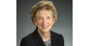 Ann Friedman, AU Baker Alumna and creator of the Planet Word Museum, smiles and wears a black blazer.