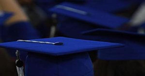 AU students sit in their graduation gear