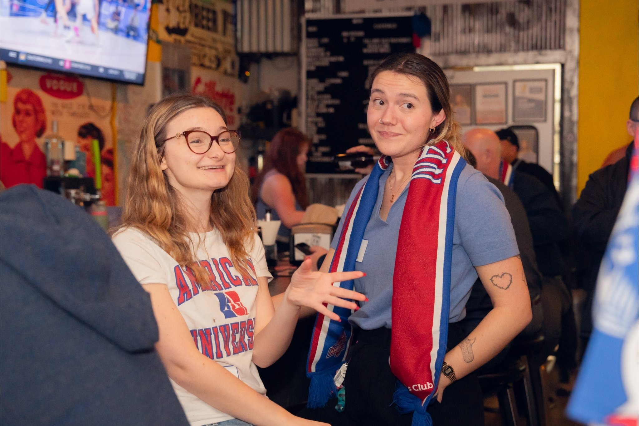 Two young AU alumni at an Eagles watch party