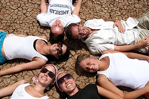 Students lay in a circle on Kenyan soil.
