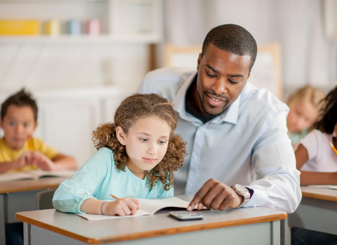 Elementary education teacher with a student