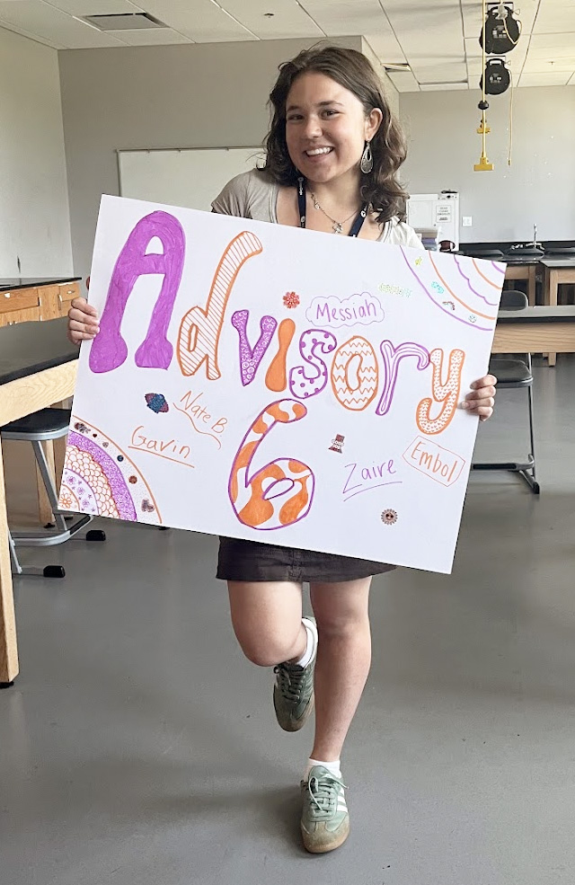 Lizzie proudly displaying her advisory sign at Jefferson Middle School in the summer of 2025.