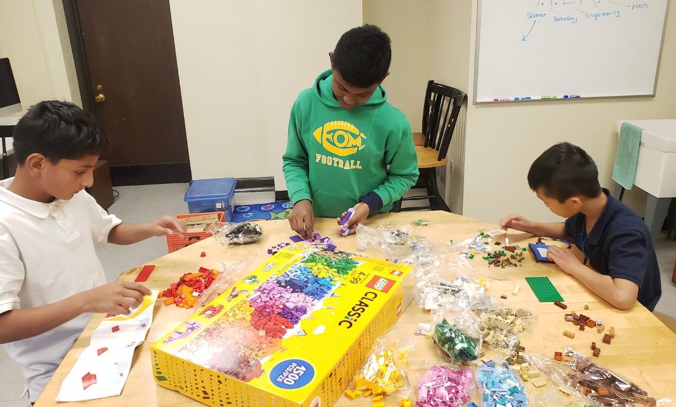 Students learn by building with Legos.
